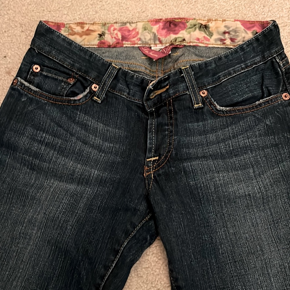 Dark wash and slightly distressed Lucky brand jeans.